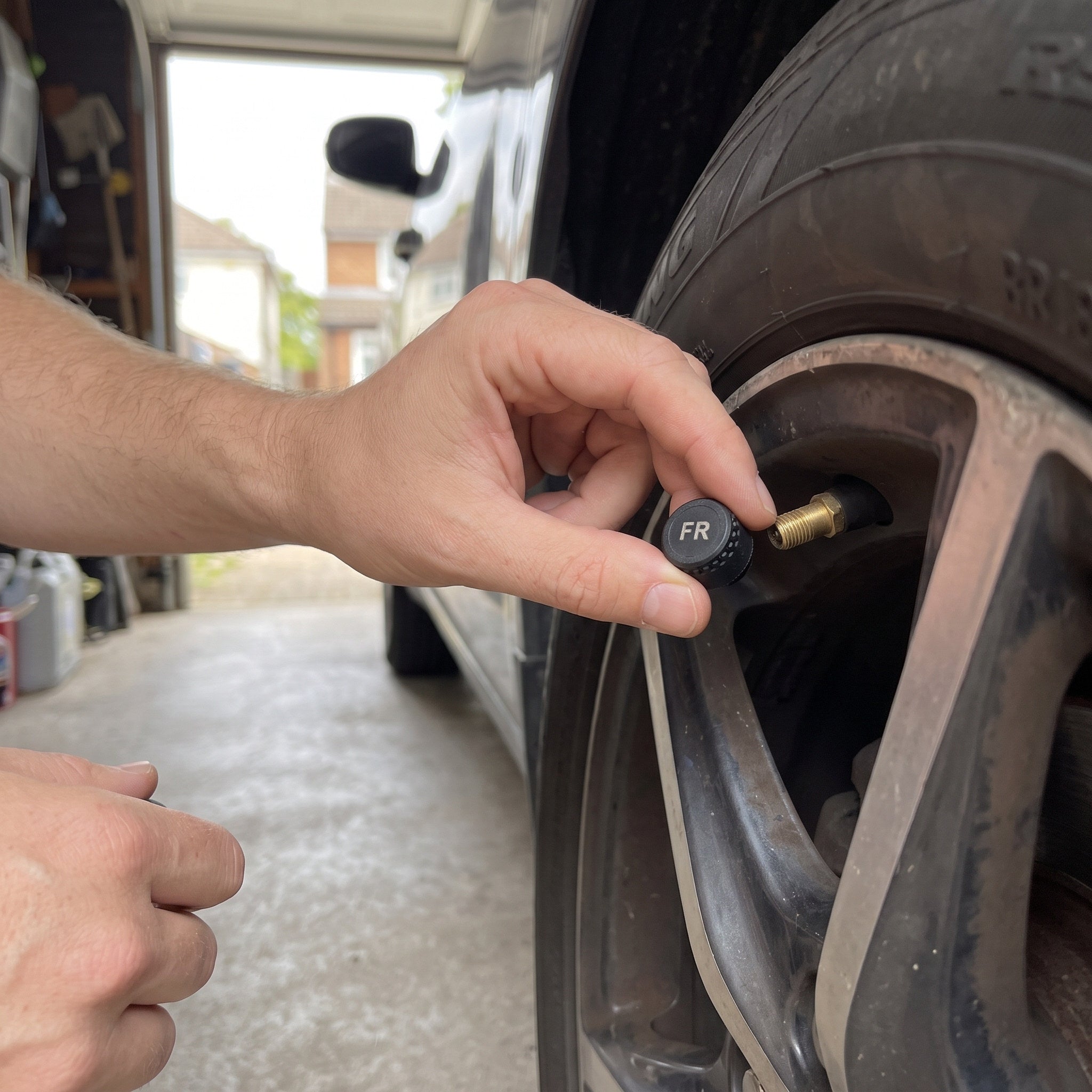 Ben photographs his hand tightening an external sensor on a tyre valve